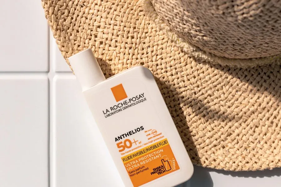 la roche posay skin care product on tiles with hat